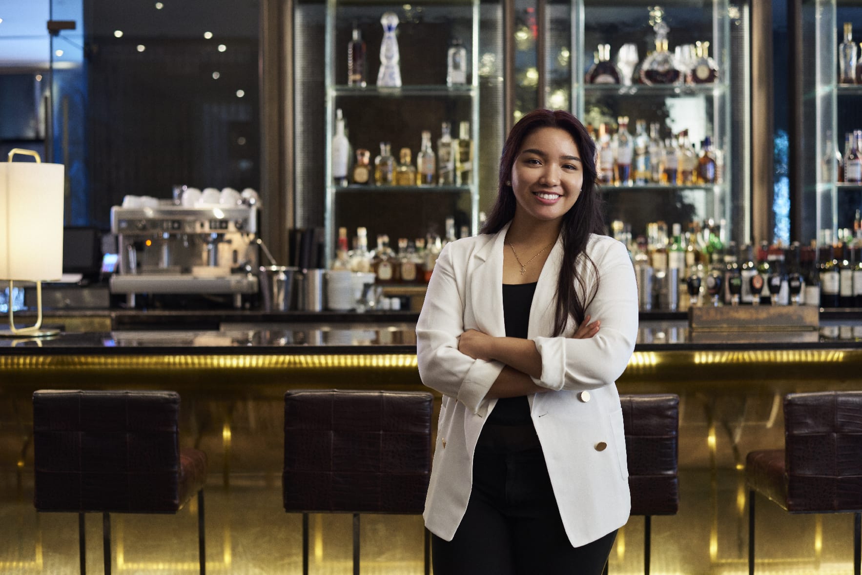 Woman standing in from of bar