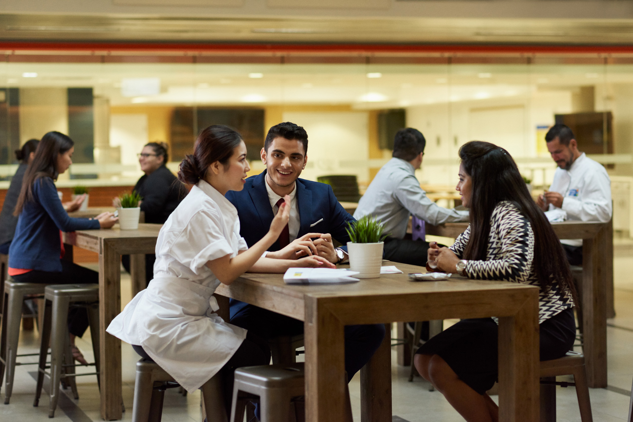 A photo of a CHCA Ambassador speaking to two individuals