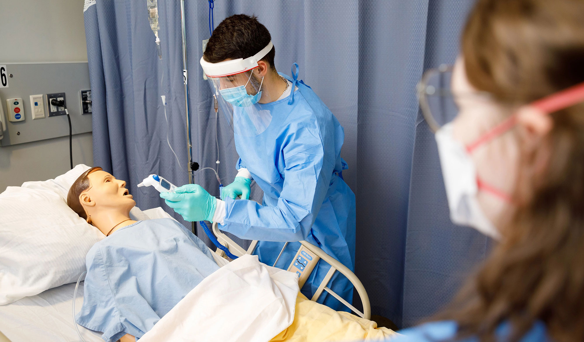 Nursing student working with mannequin