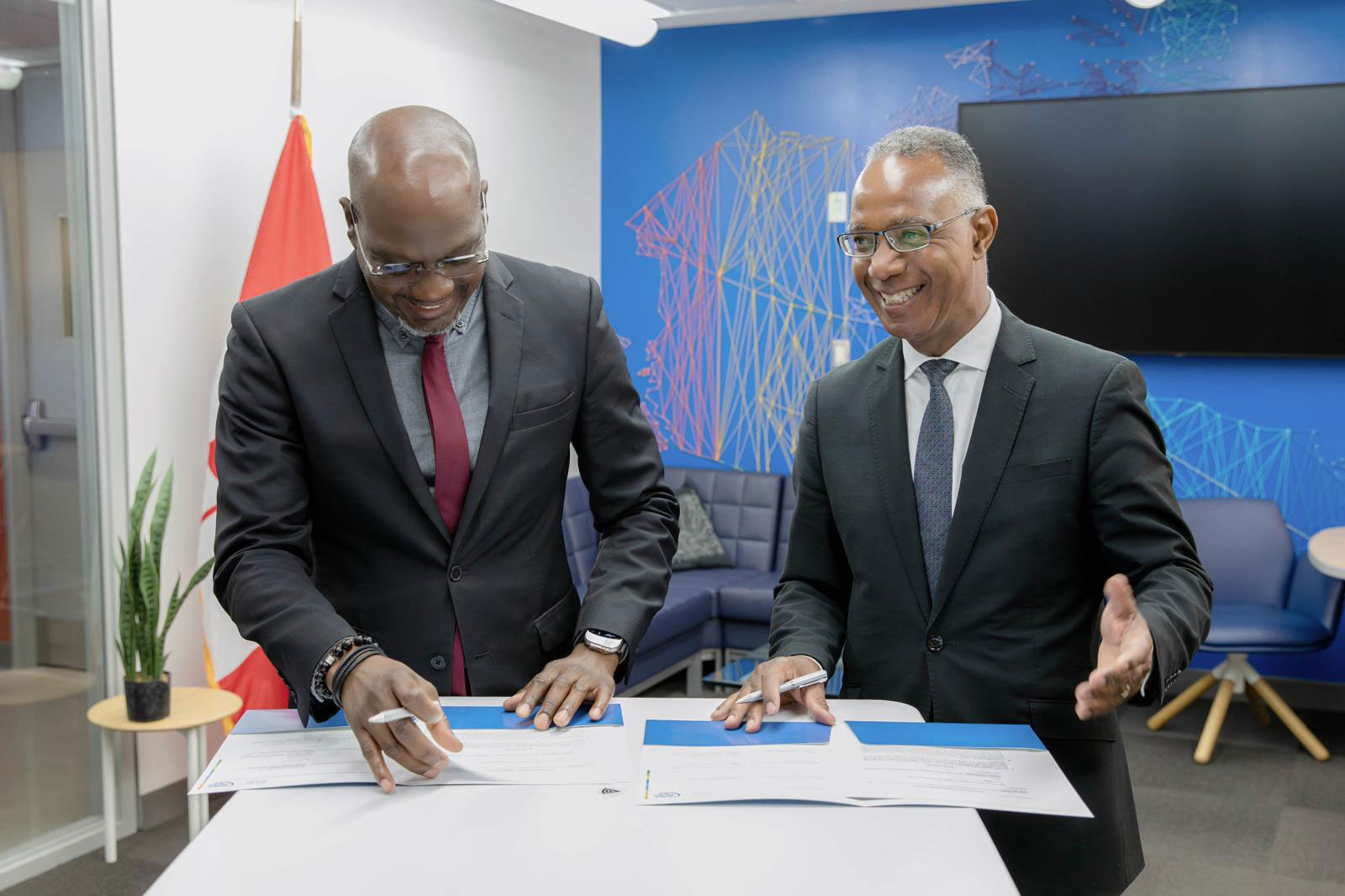 Honourable Daryll Matthew and President Fearon signing the MOU
