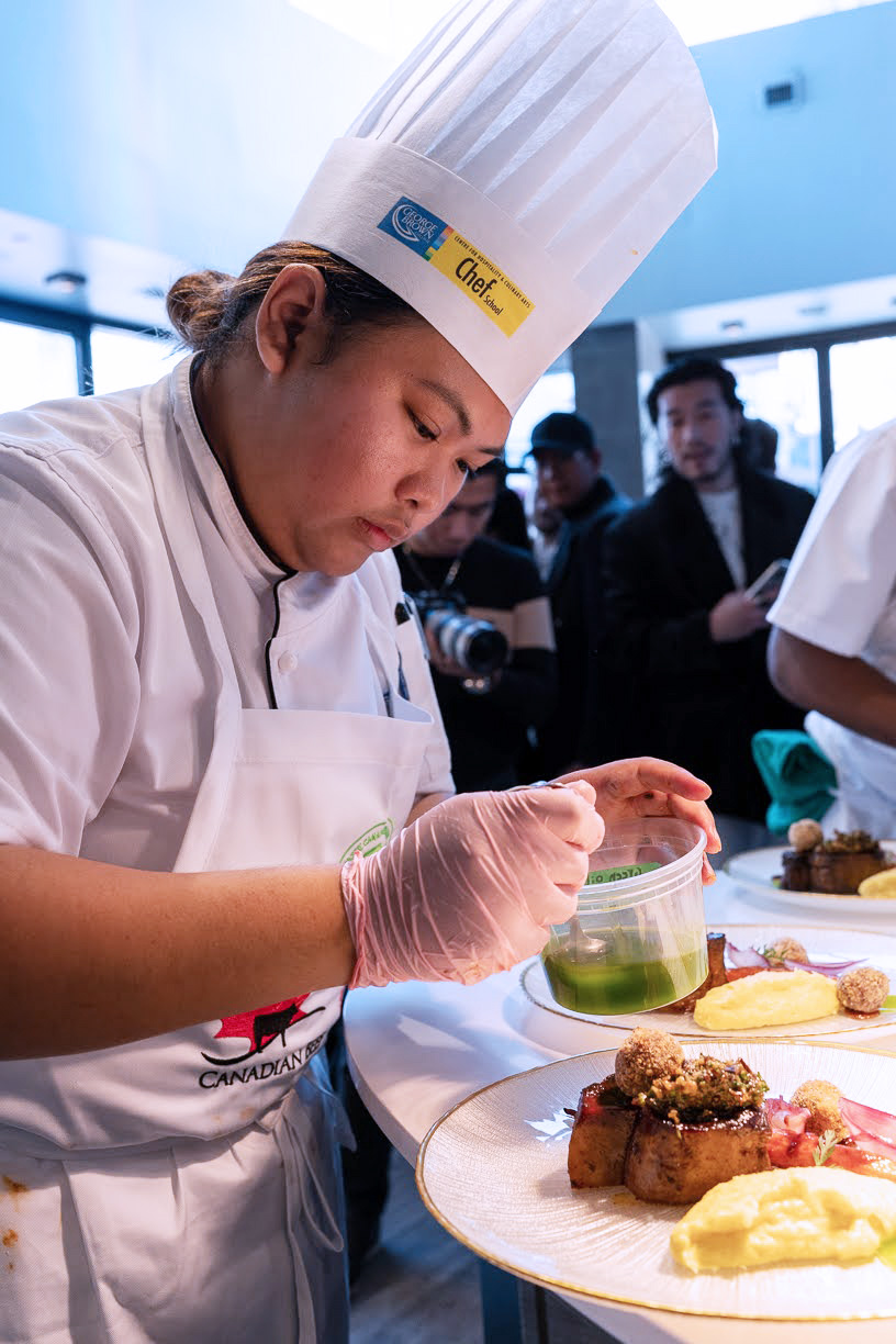 Francine Adriosula preparing a dish at the Cooks the Books competition