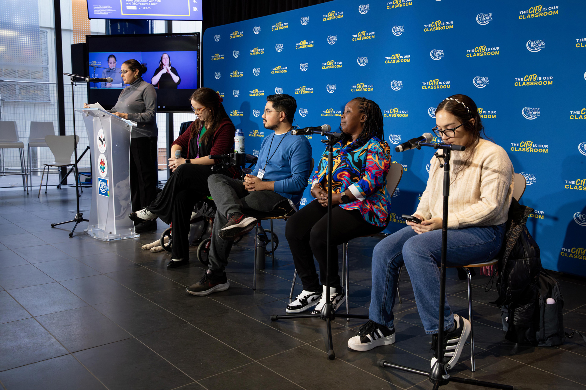 A group of students seated with microphones