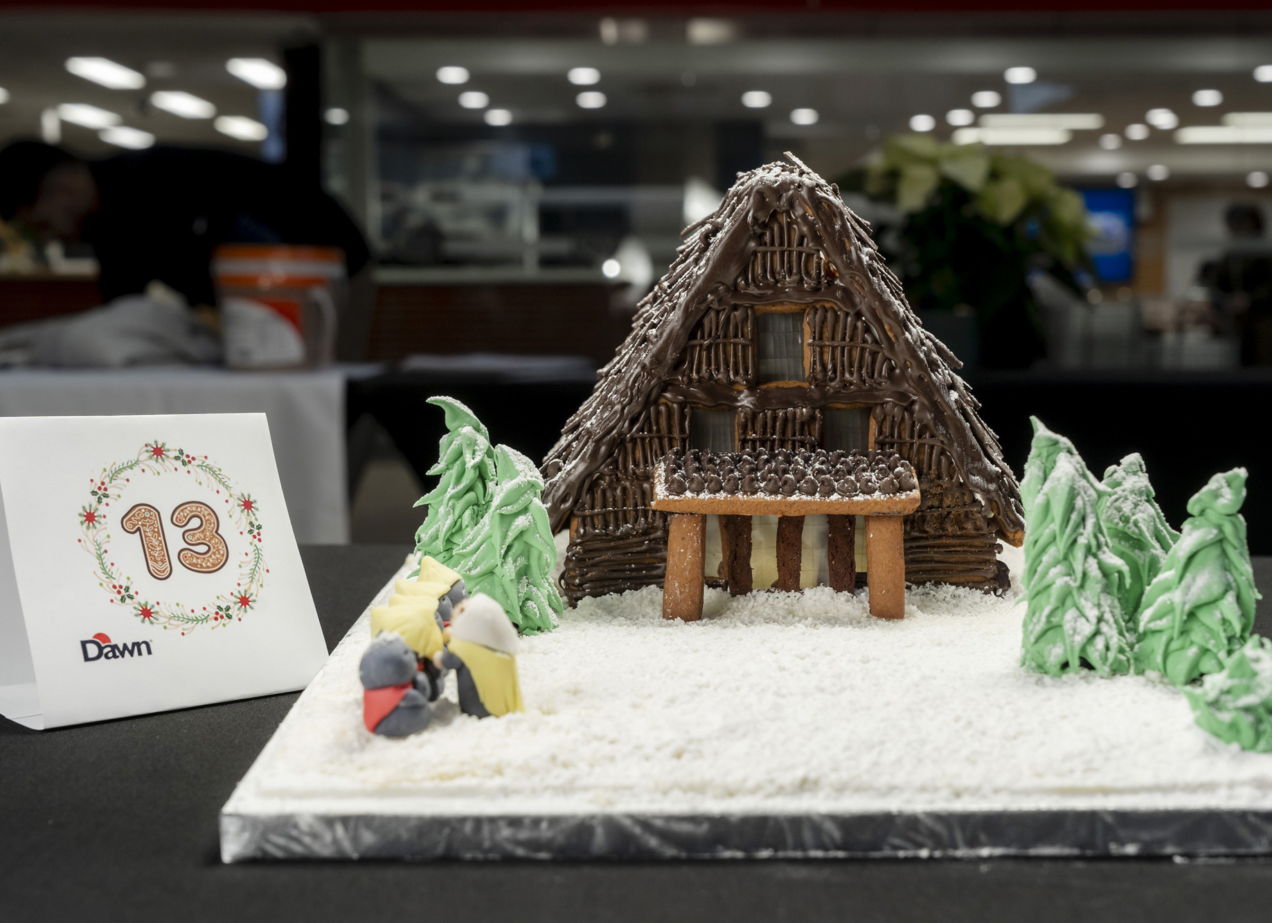 A chocolate and snow covered gingerbread house