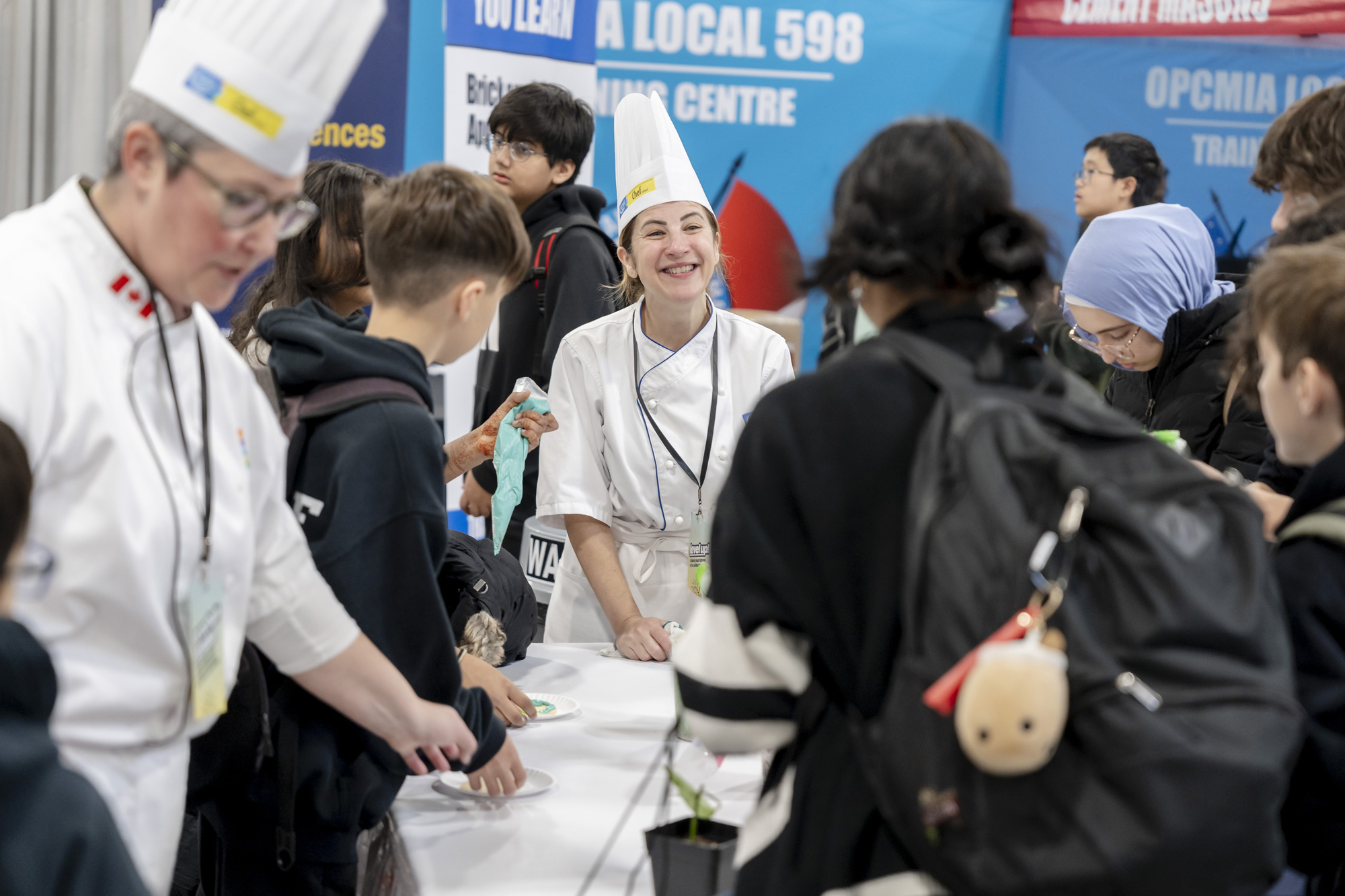 Chef surrounded by group of young students