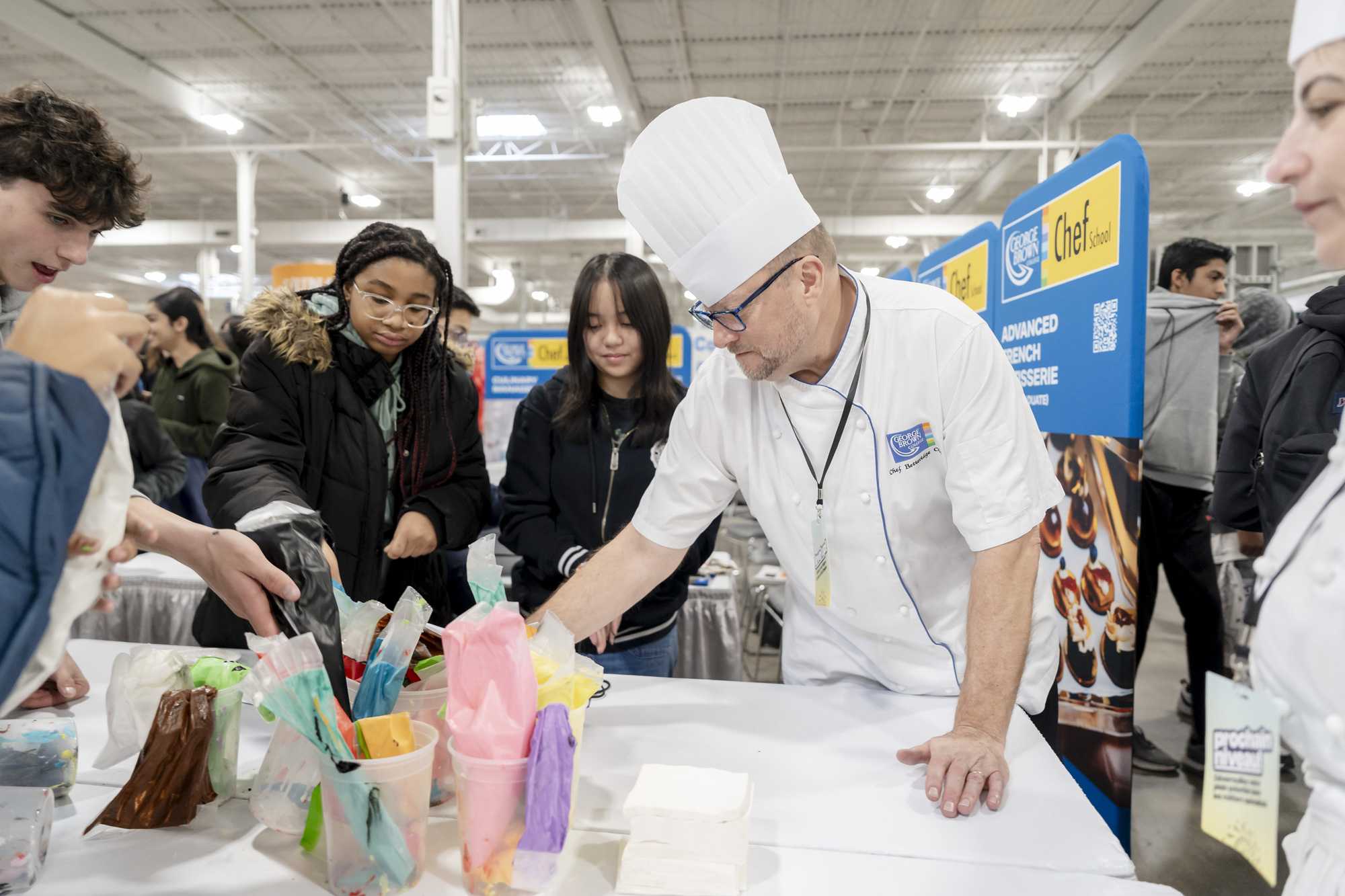 Chef guides students on cookie decorating