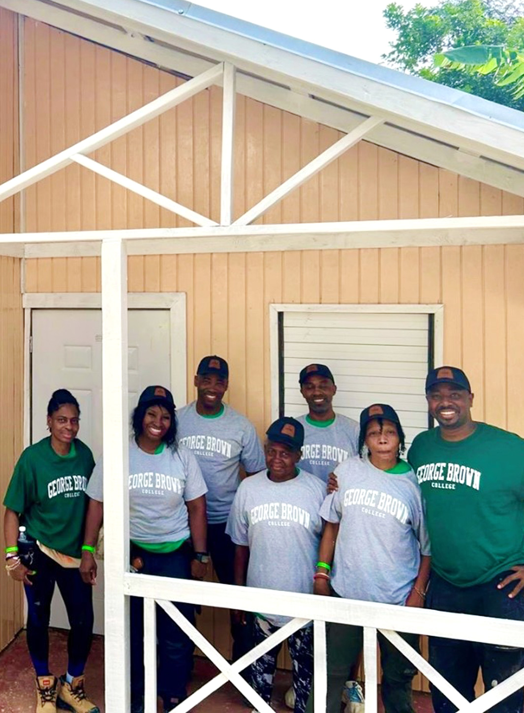 Rokhaya Gueye and volunteers outside of the volunteer built home in Jamaica