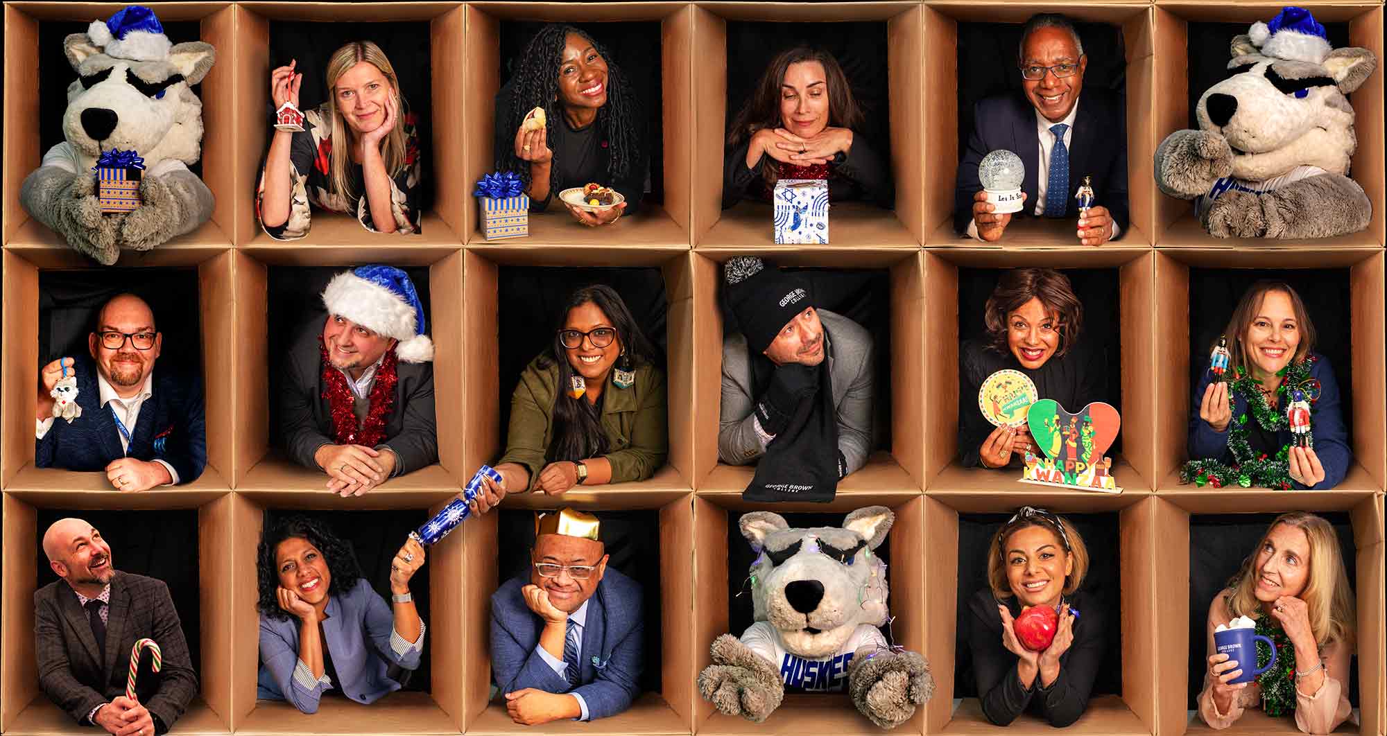 George Brown senior leaders posing with holiday items with Helder the Husky