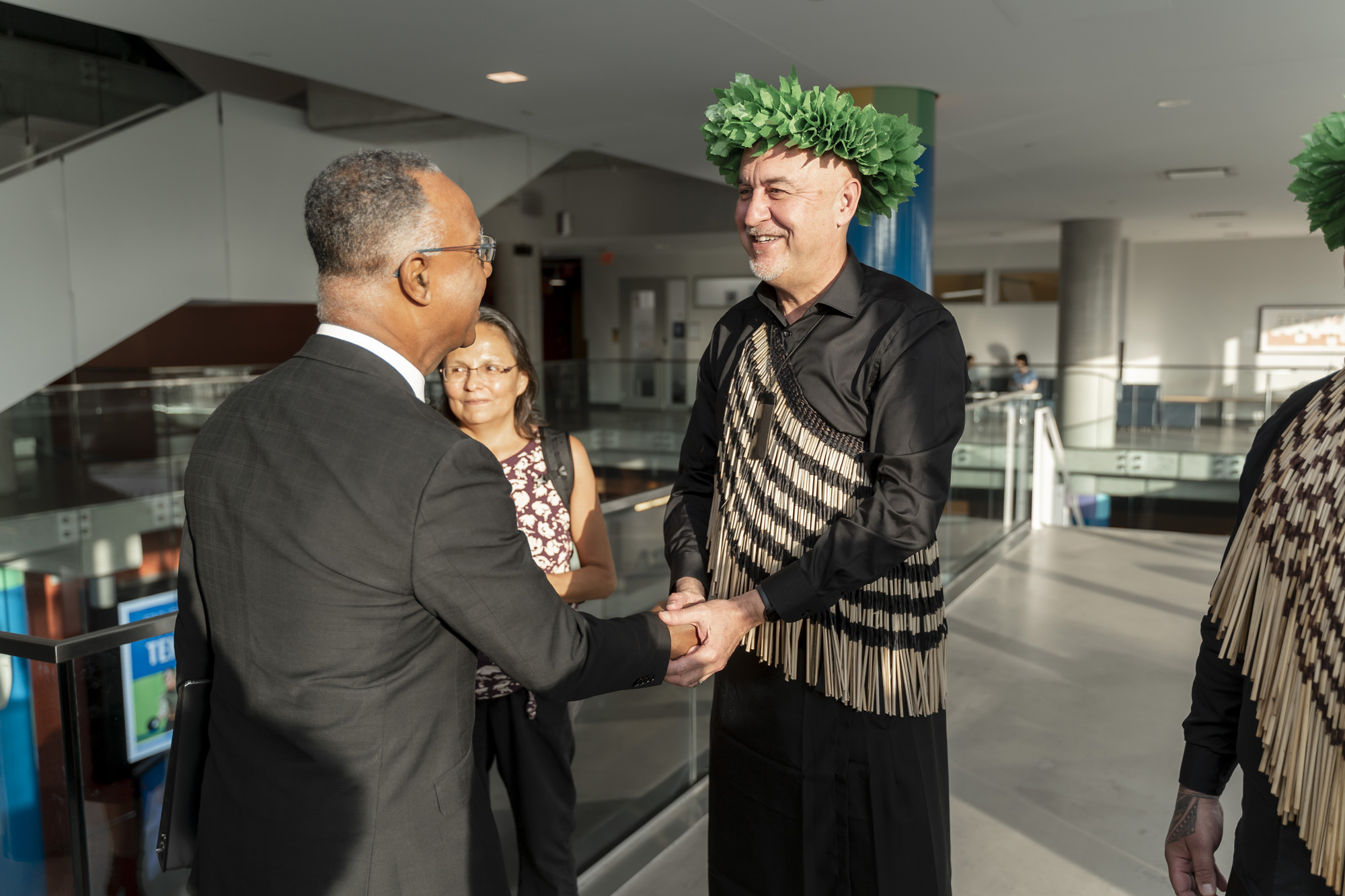 A Maori man shakes Dr. Gervan Fearon's hand