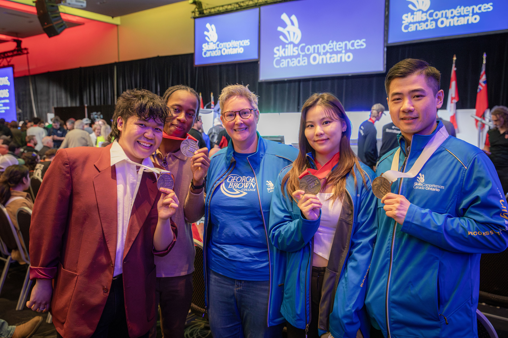 Group of people holding medals