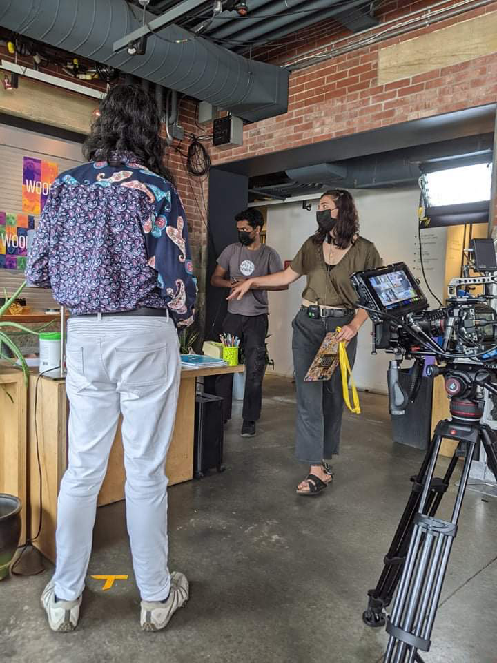 Fateema Al-Hamaydeh Miller standing on set amidst cameras and crew