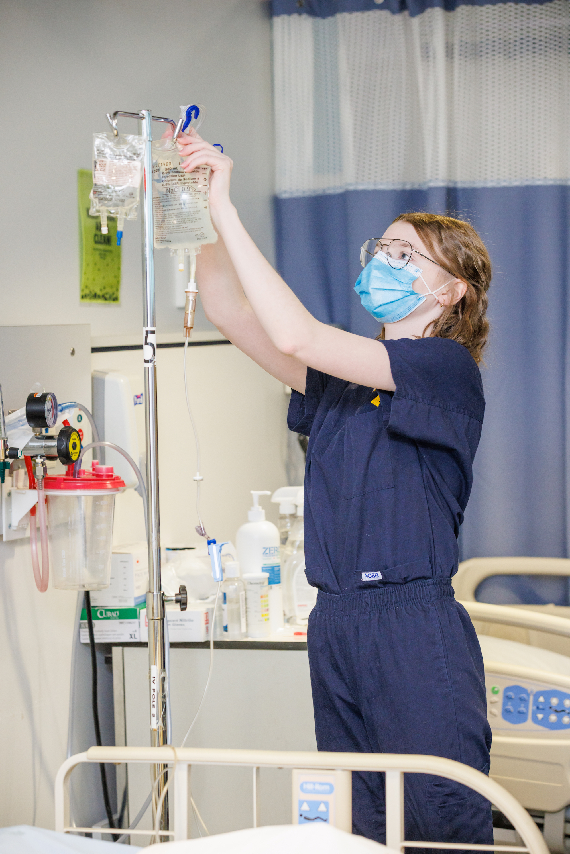 A nursing student works with IV equipment in the Simulation Centre. 