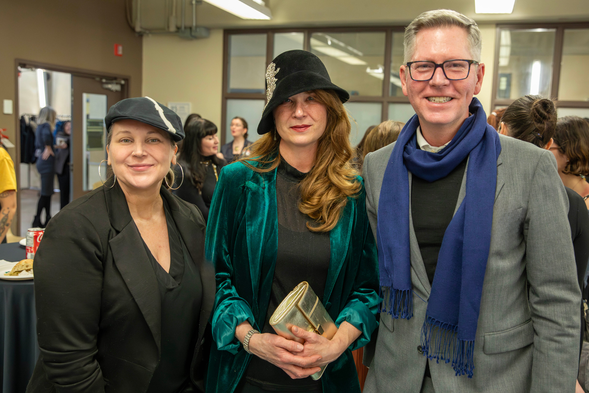 Three individuals smiling and posing together for a photograph at the chapter launch.