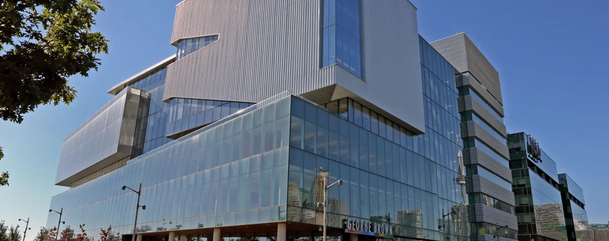 Exterior of Waterfront Campus, panned out with tree framing the side.