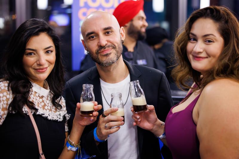 Guests holding beverages at the Food Court Social