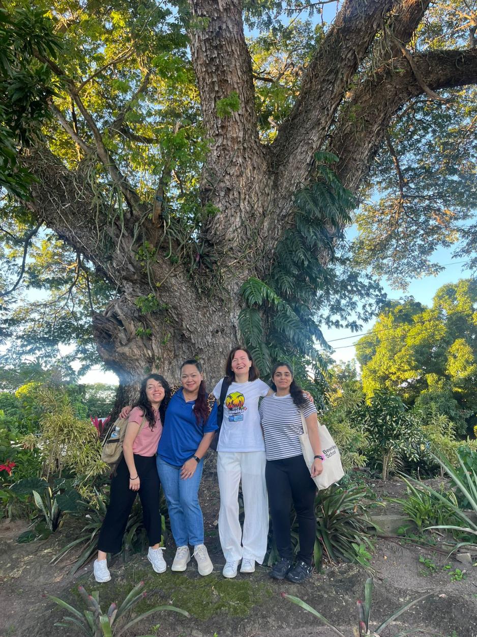 Jamaica Project 2025 students standing outside the Wisdom Tree at Shortwood school